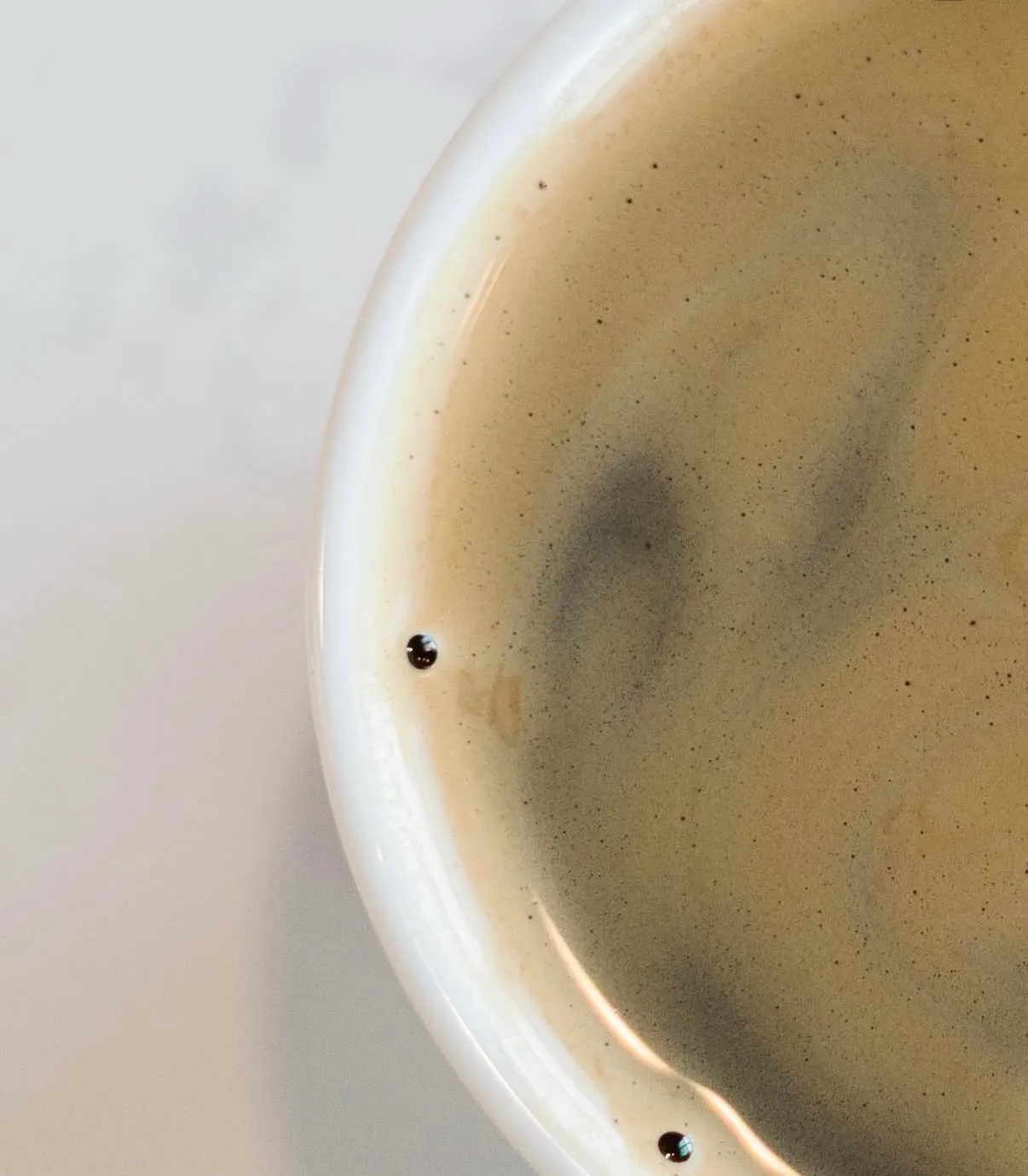 A close-up of the crema on a fresh espresso in a white cup at The Brew Cafe