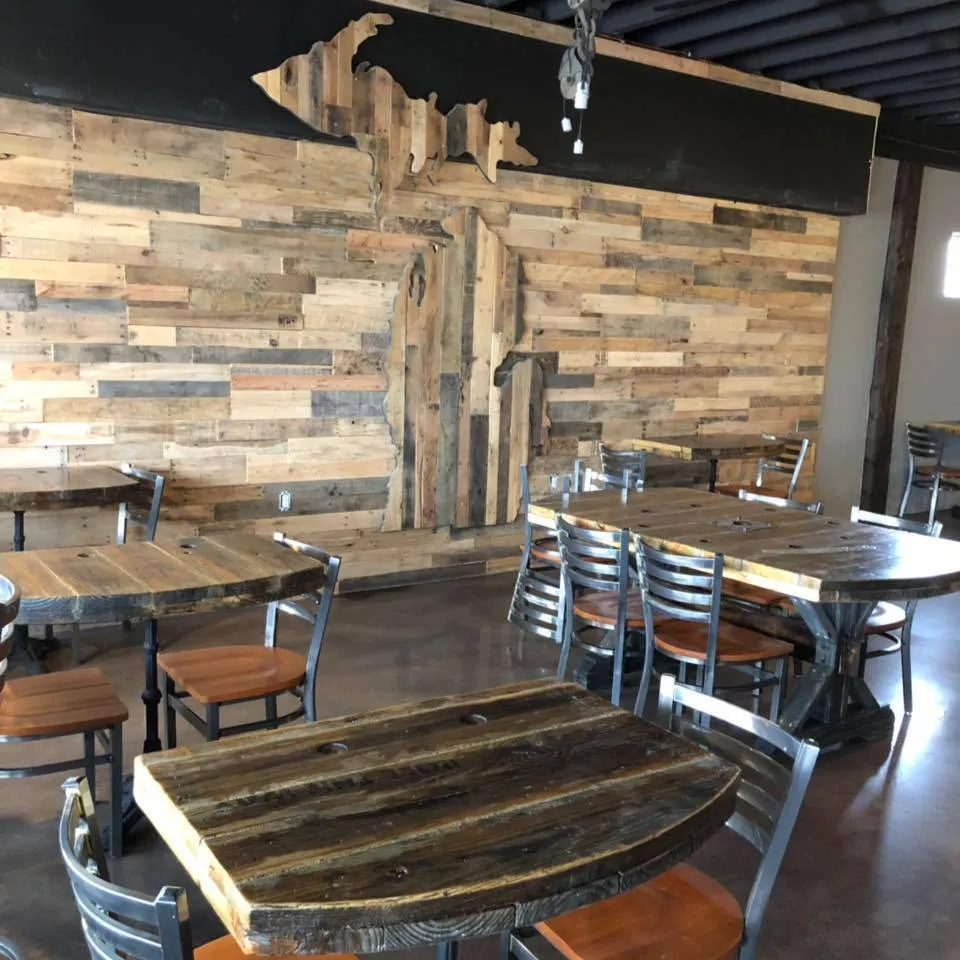 Reclaimed wood tables and the Michigan wall inside The Brew Cafe